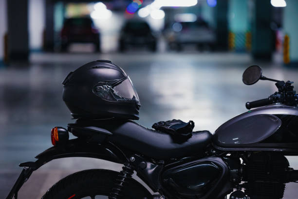 istock Black Helmet and Gloves on a Motorcycle Parked in a Public Garage 2078243714