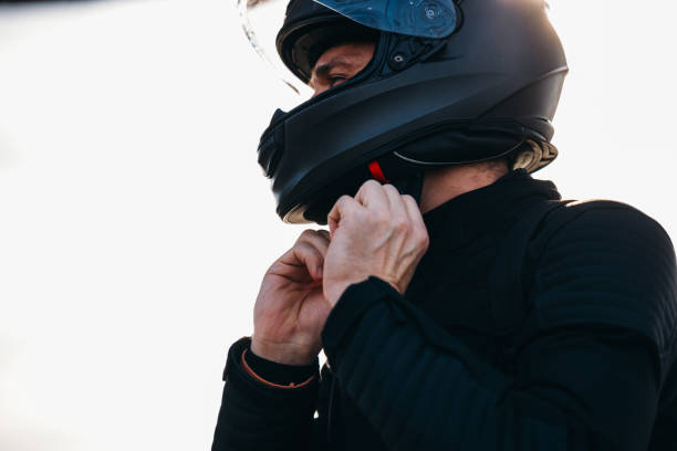 istock Anonymous Motorcyclist Putting on a Helmet and Getting Ready for a Ride 2078244263