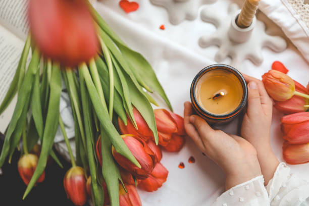 istock A girl holds a candle in her hands, spring mood 2078248691