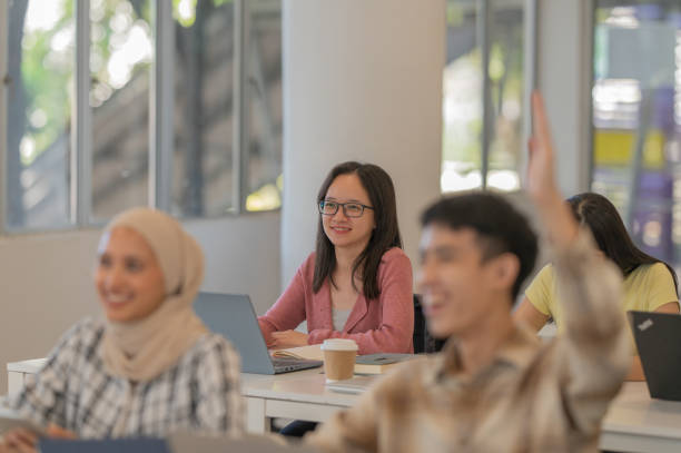 istock Asian student rise hand in classroom 2078256673