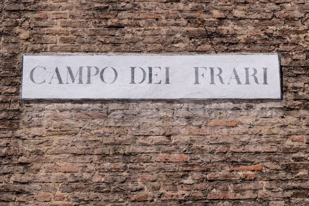 Venice, Veneto - Italy - 06-09-2021: The 'Campo dei Frari' sign mounted on an exposed brick wall in Venice