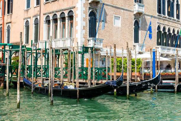 Venice, Veneto - Italy - 06-10-2021: The Gritti Palace Hotel, a Gothic gem, flanks Venice's Grand Canal with gondolas poised at its front