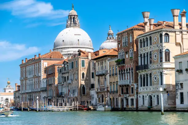 Photo of Historic Venetian Palaces Along the Grand Canal Under Blue Skies