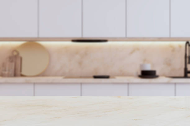 istock An empty, modern kitchen interior with a marble tabletop in the foreground and a blurred counter in the background. 3D Rendering 2078266988