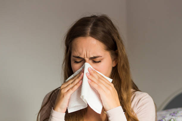 istock Woman blowing her nose 2078267511