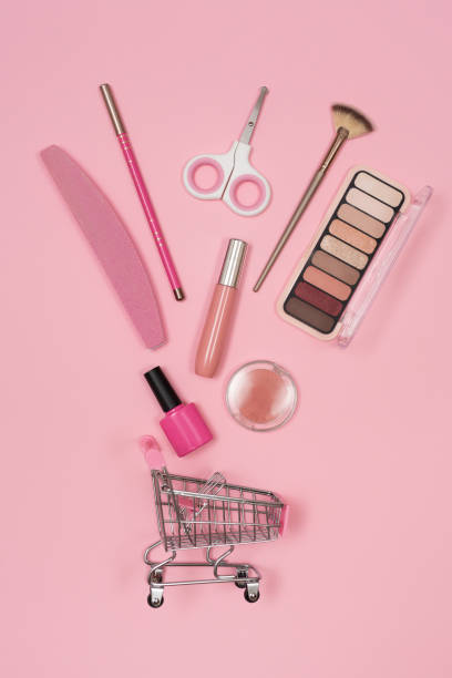 istock Creative concept with shopping trolley with makeup on a pink background 2078292726