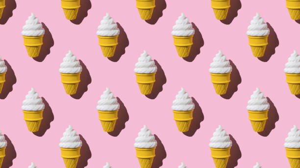 istock A pattern of cups with fresh cream ice cream on a pink background. 2078305297