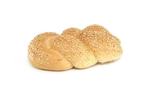 Golden braided sesame bread isolated on white