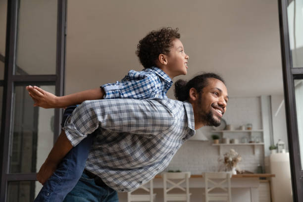 istock African father rides his little son on back 2078311633