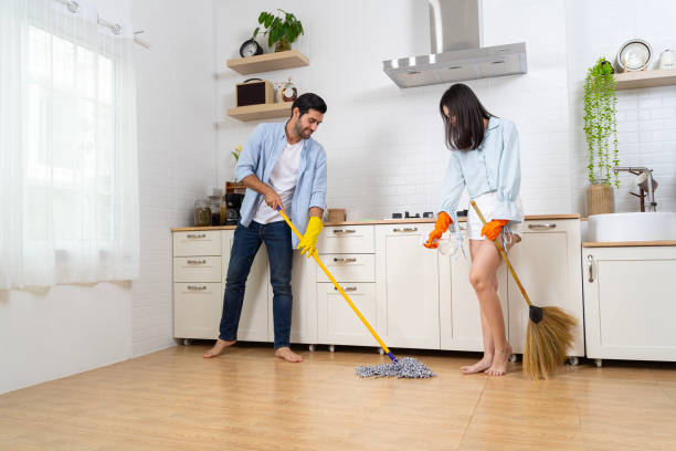 istock Happy couple cleaning kitchen together and looking at each other. 2078318623