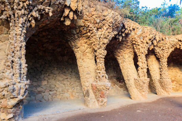 Rocks Arranged to Create an Arched, Wave-Shaped Tunnel in Park Güell, Barcelona, Spain at Sunset