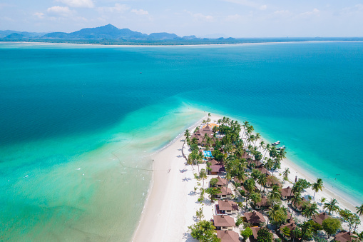 top view at Koh Muk a tropical island with palm trees and soft white sand, and a turqouse colored ocean, Koh Mook Island Trang Thailand