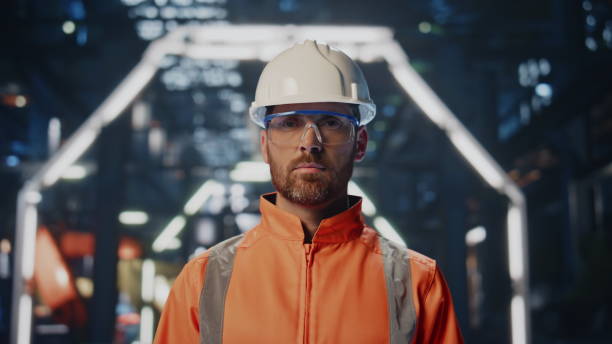 istock Skilled factory worker posing at large production warehouse in uniform closeup. 2078319734