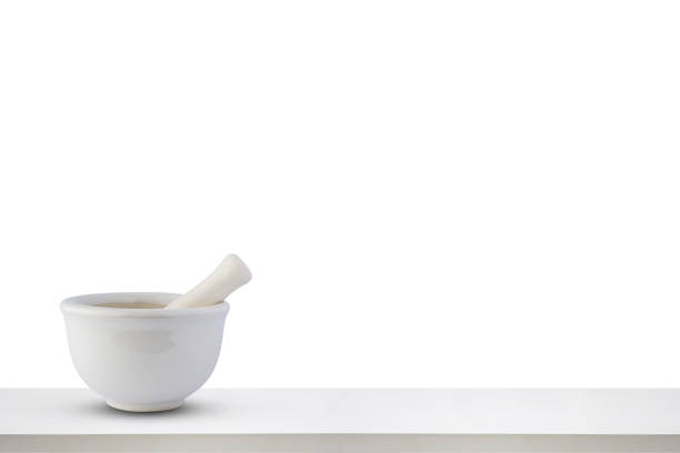 Mortar and pestle on white wooden table top isolated on white background pharmacy concept