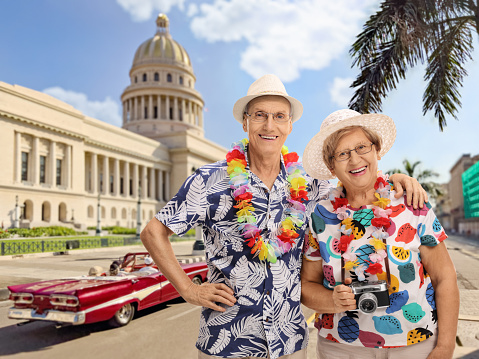 Happy mature couple tourists posing together in Havana, Cuba