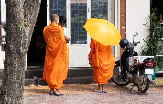 Phnomh Penh, Cambodia on Feb 24, 2024: a common sight in Cambodia are buddhist monks, many of them adolescents who collect money for their daily living