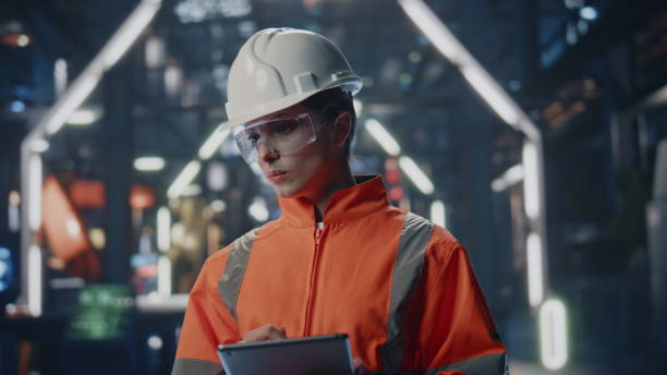 istock Serious factory inspector looking industrial facility holding tablet close up. 2078339480