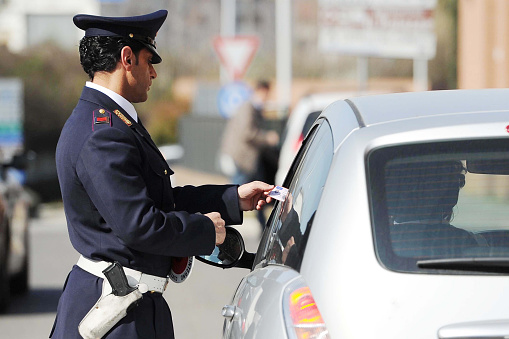 On this day the Italian police forces checked several cars to counter the drug and alcohol smuggling driving. They also checked driver’s licenses and insurance. in the photo a police patrol and uniformed officers.