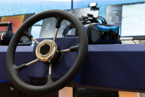 Marine navigation simulation system, ship control panel with steering wheel and VR headset on the desk