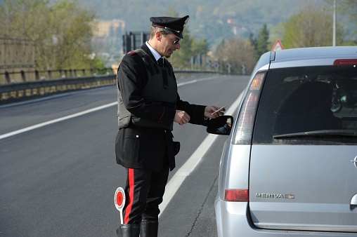 On this day the Italian police forces Carabinieri have checked several cars to combat the drug and alcohol traffic. They also checked driver’s licenses and insurance. in the photo a police patrol and uniformed officers.