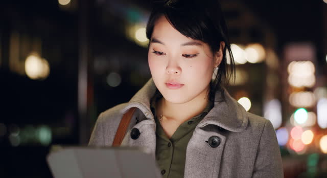 Business woman, city and tablet at night to scroll website, reading information and update app online. Japanese worker with digital software, social network or search internet in dark street of Tokyo
