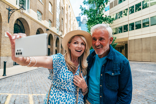 Happy senior couple spending time together in London city. Concepts about seniority, lifestyle and travel