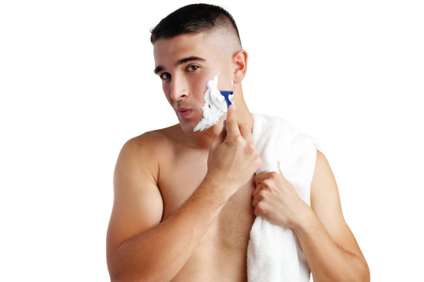 istock Young handsome man applying shaving foam against white background 2078430962