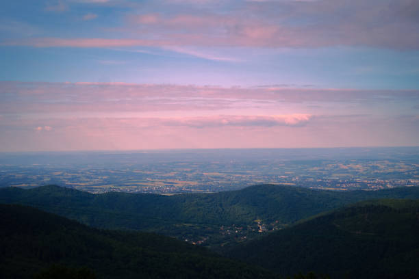 Pink clouds, sunrise over the mountains, view of the village in the mountains