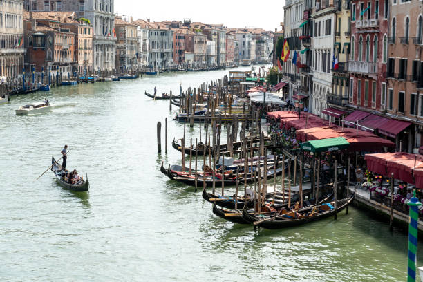 Venice, Veneto - Italy - 06-09-2021: A busy day on Venice's Grand Canal, with gondolas and vibrant cafes