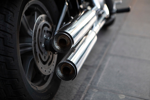 Close-up of a motorbike parked on a pavement