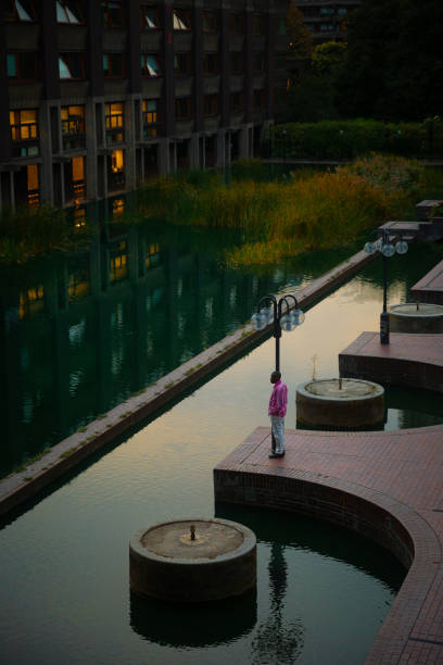 September 22, 2022: A man standing in urban context of brutalist Barbican in London