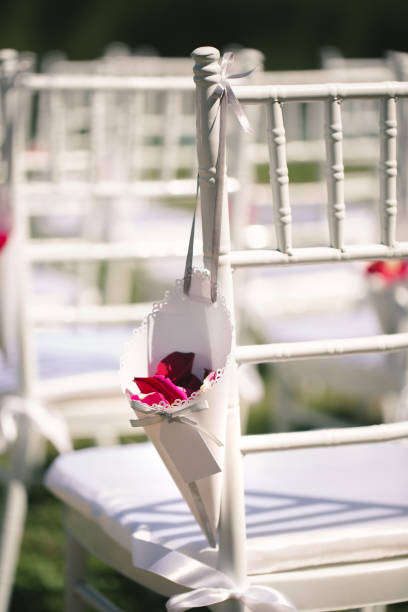 istock White chairs at the wedding ceremony with rose petals. 2078489919