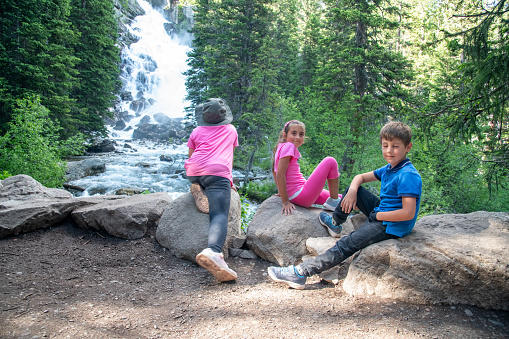 A happy group of young children visiting Yellowstone National Park.