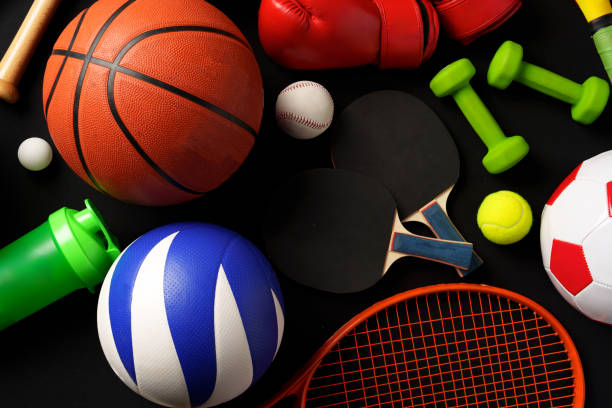 Various sports equipment on black background studio shot close up