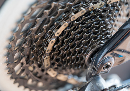 Detail of twelve speed cassette with chain. On a mountain bike. Blurred background.