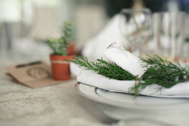 serving a wedding banquet. a plate with a napkin and a sprig of juniper. - banquet table set restaurant imagens e fotografias de stock