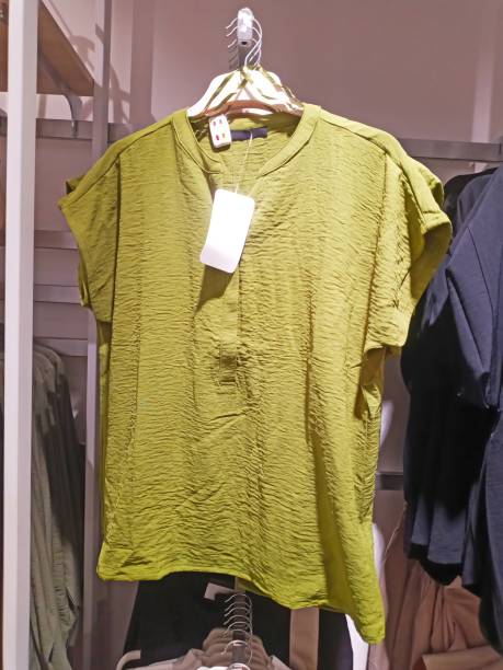 istock green blouse hanging on a hanger in a boutique 2078506685