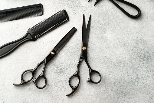 Hairdressing tools set on light gray background close up