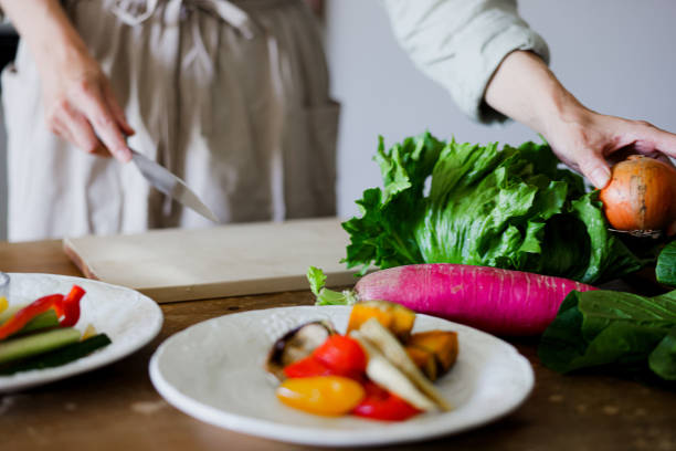 Female hands as they prepare a vegan meal.