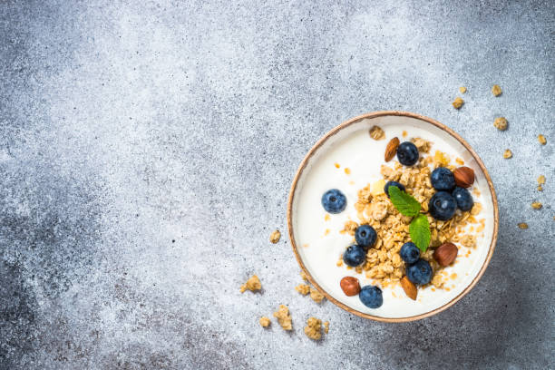 istock Yogurt granola with fresh blueberries on stone table. 2078524395