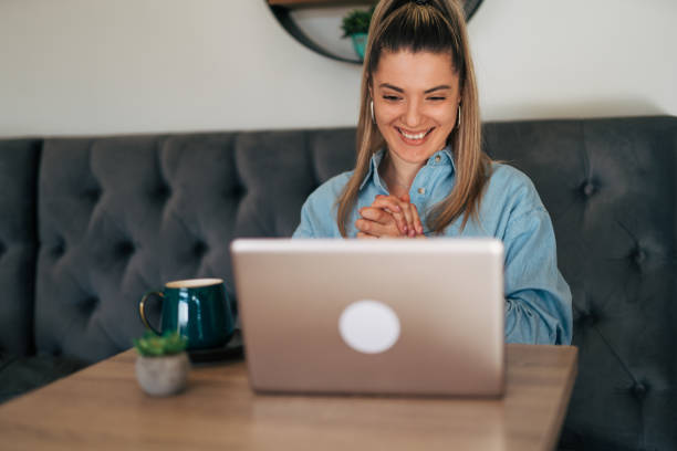istock Young woman on video call at cafe. 2078530680