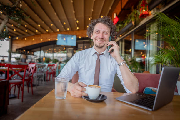 istock Businessman talking on a mobile phone at cafe 2078531246