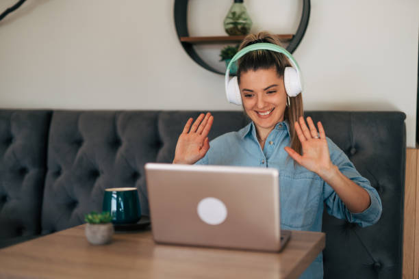 istock Young woman on video call at cafe. 2078533833