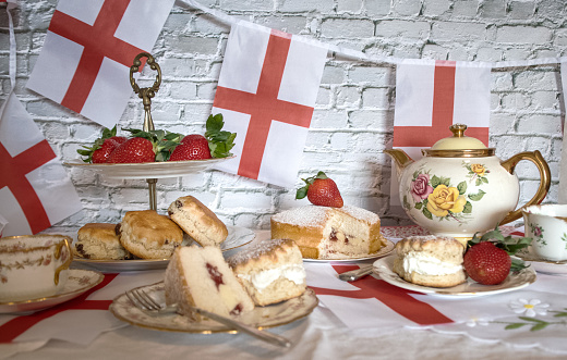 afternoon tea  celebration  vintage tea  party  tradition scones  strawberries and  cream  victoria  soponge  and  English  flag  bunting