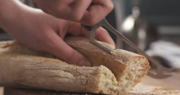 istock closeup slicing fresh baguette on cutting board 2078553423