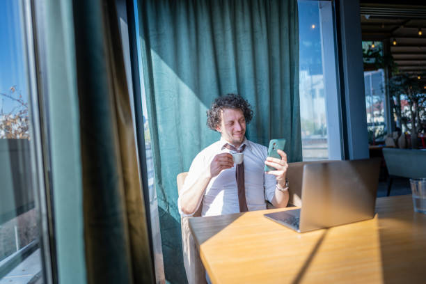 istock Business man drinking coffee and working in cafe 2078554461