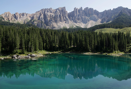 A landscape photo with a view of the mirror surface of the lake and mountains reflected in the lake