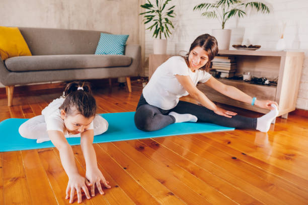 istock Pregnant mother exercising with her daughter 2078575826