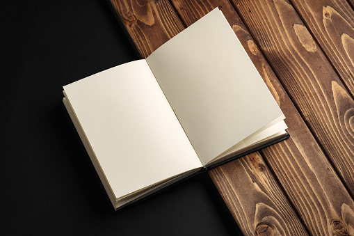 Blank notepad on a brown wooden surface close up