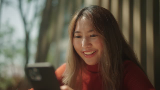 Happy woman using smartphone.